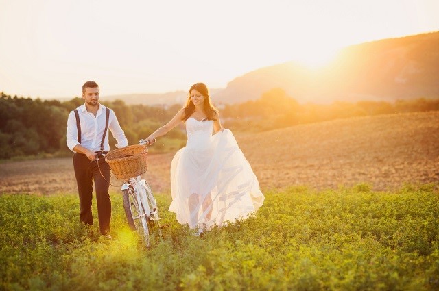 Bride and groom with a white wedding bike