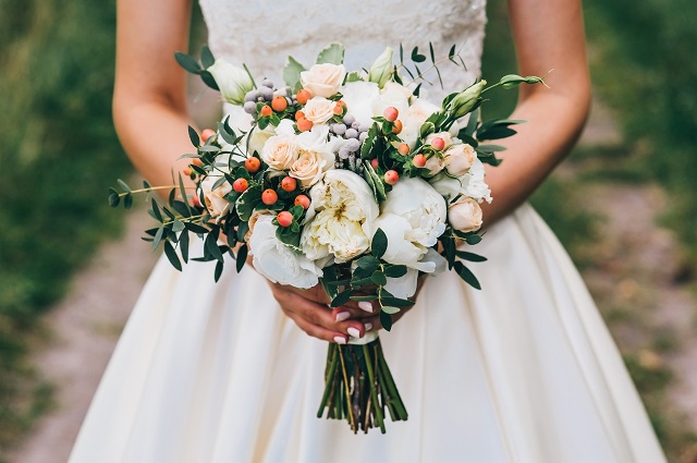 bride holding a bouquet of flowers in a rustic style, wedding bouquet