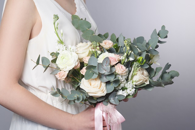 Gentle wedding bouquet in hands of the bride.